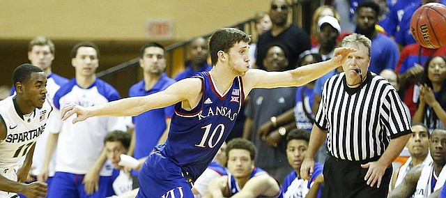 Kansas guard Sviatoslav Mykhailiuk (10) chases a loose ball with Michigan State guard Lourawls Nairn Jr. (11) during the second half on Sunday, Nov. 30, 2014 at the HP Field House in Kissimmee, Florida.