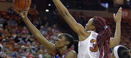 Kansas forward Chelsea Gardner, center, shoots against Texas center Imani McGee-Stafford, second from right, during the first half an NCAA college basketball game, Saturday, Jan. 3, 2015, in Austin, Texas. (AP Photo/Michael Thomas)