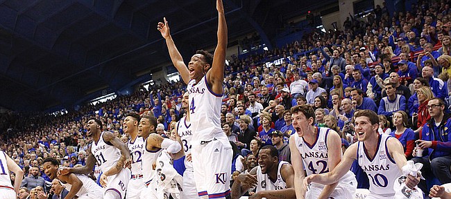 Kansas guard Devonte Graham (4) leaps off the bench to celebrate a bucket by reserve Christian Garrett late in the second half on Saturday, Jan.10, 2015 at Allen Fieldhouse.