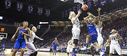 Kansas senior guard Asia Boyd (0) loses the ball under the basket while being double teamed by Kansas State's Shaelyn Martin (50) and Breanna Lewis (22) during the second half of their game Sunday afternoon at Bramlage Coliseum in Manhattan. Despite a quick start by the Jayhawks that saw them surge to a 14 point lead, Kansas fell to the Wildcats, 58-52, and dropped to 0-3 in Big 12 play.
