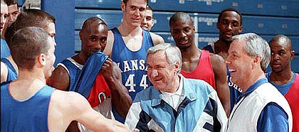 Former North Carolina coach Dean Smith, center, meets members of
Kansas University's 1997-98 men's basketball team. Smith, who
played at Kansas for coach Phog Allen, has recently become a vocal
opponent of the death penalty.