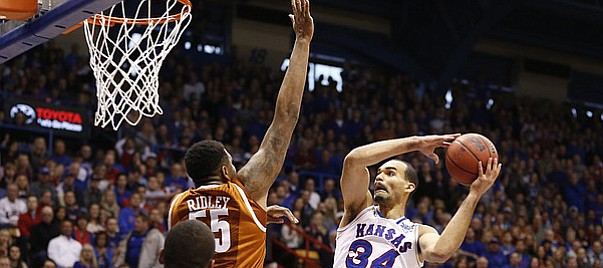 Kansas forward Perry Ellis (34) heads to the bucket against Texas center Cameron Ridley (55) during the first half on Saturday, Feb. 28, 2015 at Allen Fieldhouse.