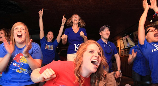 A group of Kansas University basketball fans cheer on the Jayhawks at Johnny’s Tavern as they defeat North Carolina in the NCAA tournament in 2012. KU fans have plenty of options when looking for a local venue to cheer on the team from afar during March Madness.
