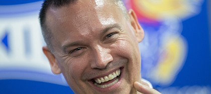 Brandon Schneider visits with reporters after his introduction Tuesday, April 21, 2015 as the new head coach of the KU women's basketball team.