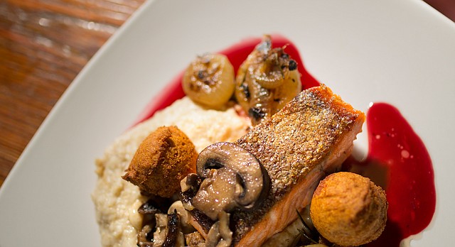 Pan-roasted ocean trout with parsnip porridge, chard cipollini, onions, Wakarusa Farm mushrooms, sorghum hush puppies in an elderberry reduction at Merchants Pub and Plate, 746 Massachusetts.