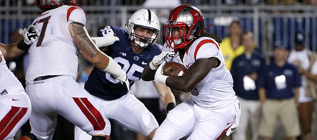 Rutgers running back Josh Hicks, right, runs during the first half of Rutgers’ 28-3 setback to Penn State on Sept. 19, 2015, in State College, Pennsylvania. Stopping Hicks and his backfield-mates is a key for Kansas University today in Piscataway, New Jersey.
