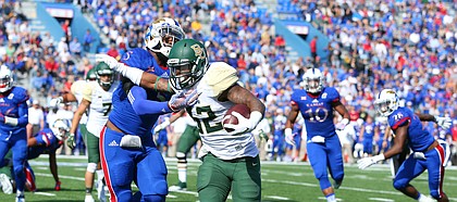 Baylor running back Shock Linwood (32) pushes aside Kansas linebacker Marcquis Roberts (5) on a run during the first quarter on Saturday, Oct. 10, 2015 at Memorial Stadium.