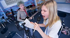 Vocalist Ada Hyde, 11, belts out the lyrics to the Girls Rock Anthem as Macie Orr, 13, plays guitar during the Girls Rock Lawrence camp, Tuesday, June 2, 2015 at Saint John's Catholic School. Both girls are performing with the band Candle Stick during the weeklong camp, which seeks to empower girls through musical collaboration and performance. The camp also aims among other things, to expunge the stigma that girls are weak. To view a video from the camp, please visit ljworld.com/girlsrock2015