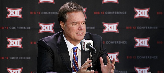 In this file photo from Oct. 15, 2014, Kansas head coach Bill Self talks about his team during a Big 12 Conference Media Day event at the Sprint Center in Kansas City, Mo.