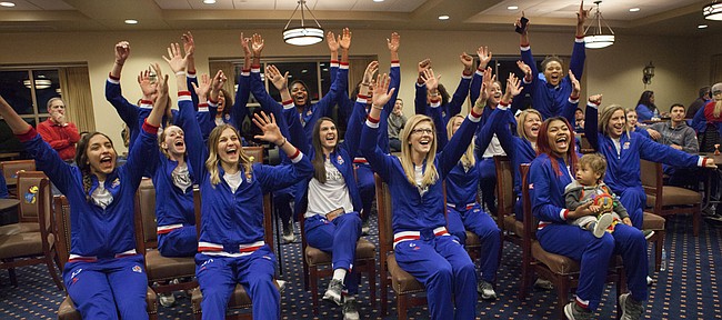Members of the Kansas University volleyball team celebrate as they learn that they received the overall No. 9 seed and will host opening-round games in the 2015 NCAA Volleyball Tournament. Kansas will play Furman on Thursday at the Horejsi Center. 