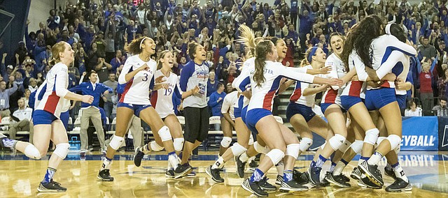 Kansas players rush the court following their three set sweep of Missouri in the second round of the NCAA volleyball tournament Friday evening at the Horejsi Center. 