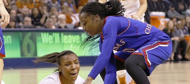 Texas guard Brianna Taylor, left, and Kansas guard Jayde Christopher vie for a loose ball during the first half of an NCAA college basketball game in the Big 12 Conference women's tournament in Oklahoma City, Saturday, March 5, 2016.