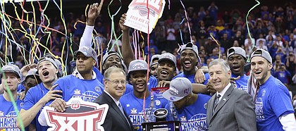 The Kansas Jayhawks celebrate with the Big 12 Tournament trophy following their 81-71 win over West Virginia, Saturday, March 12, 2016 at Sprint Center in Kansas City, Mo.