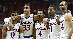 The Kansas starters, Frank Mason III, Landen Lucas, Devonte Graham, Wayne Selden Jr. and Perry Ellis stand arm-in-arm late in the second half as they watch a pair of UConn free throws with the game wrapped up, Saturday, March 19, 2016 at Wells Fargo Arena in Des Moines.