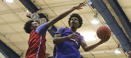 Blue Team guard Josh Jackson scoops a shot under Red Team guard Devonte Graham during the Bill Self basketball camp alumni scrimmage, Wednesday, June 8, 2016 at the Horejsi Athletic Center.