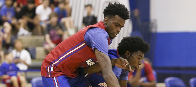 Red Team guard Lagerald Vick and Blue Team guard Josh Jackson compete for a loose ball during the Bill Self basketball camp alumni scrimmage, Wednesday, June 8, 2016 at the Horejsi Athletic Center.