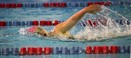 Kansas University freshman Libby Walker catches a breath during the 1,000-yard freestyle on Friday, Oct. 23, 2015, at Robinson Natatorium.