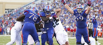 Kansas running back Taylor Martin (24) gets across the goal line past Rhode Island linebacker Justin Hogan (22) during the second quarter on Saturday, Sept. 3, 2016 at Memorial Stadium.