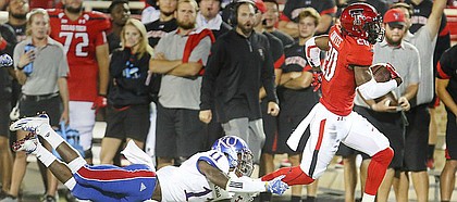 Kansas linebacker Mike Lee (11) can't hang on as Texas Tech receiver Keke Coutee (20) slips away on a touchdown run during the third quarter on Thursday, Sept. 29, 2016 at Jones AT&T Stadium in Lubbock, Texas.