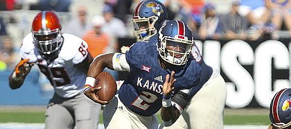 Kansas quarterback Montell Cozart (2) takes off on a run during the second quarter on Saturday, Oct. 22, 2016 at Memorial Stadium.