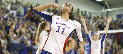 Kansas setter Ainise Havili (11) pumps her fist during Saturday's win against Texas. The Jayhawks beat the Longhorns in five sets.