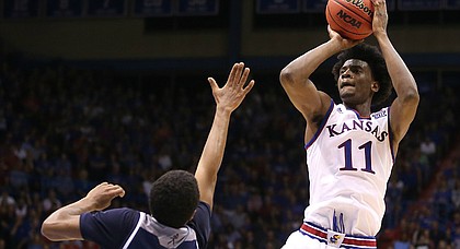 Kansas guard Josh Jackson (11) pulls up for a shot over Washburn guard Cameron Wiggins (11) during the second half, Tuesday, Nov. 1, 2016 at Allen Fieldhouse.