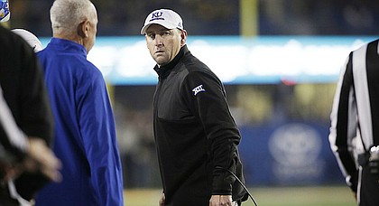 Kansas coach David Beaty argues with the officials during the first half of the team's NCAA college football game against West Virginia, Saturday, Nov. 5, 2016, in Morgantown, W.Va.