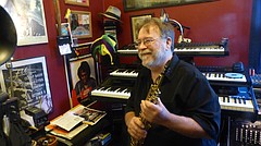 Local musician Gary Frager, pictured here in his Lawrence home on Nov. 10, will be inducted into the Kansas Music Hall of Fame next spring with his band, Caribe. The band, which was active on and off throughout the 1980s and 90s, was known for its reggae-Latin sound. 