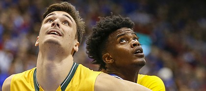 Kansas guard Lagerald Vick looks to spin off of Siena forward Evan Fisher (32) during the second half, Friday, Nov. 18, 2016 at Allen Fieldhouse.