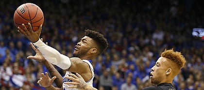 Kansas guard Frank Mason III (0) gets in for a bucket past Long Beach State guard Noah Blackwell (3) during the first half, Tuesday, Nov. 29, 2016 at Allen Fieldhouse.