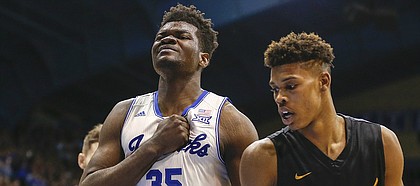 Kansas center Udoka Azubuike (35) pounds his chest after a dunk during the second half, Tuesday, Nov. 29, 2016 at Allen Fieldhouse. At right is Long Beach State forward LaRond Williams.