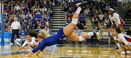 Kansas setter Anise Havili (11), left, and Kansas libero Cassie Wait (5) dive for an attempted dig during the Jayhawks three-set sweep against Samford University in the first round of the NCAA women’s volleyball tournament Thursday, Dec. 1, at Horejsi Family Athletics Center.
