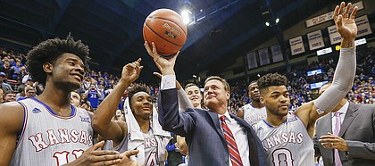 Kansas head coach Bill Self raises up a ceremonial ball commemorating his 600th win as he celebrates with his players and those attending the Jayhawks' 105-62 win over UMKC, Tuesday, Dec. 6, 2016 at Allen Fieldhouse.