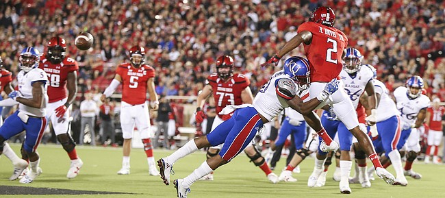 Kansas defensive end Dorance Armstrong Jr. (2) puts a hit on Texas Tech wide receiver Reginald Davis III (2) after Davis dropped a pass during the second quarter on Thursday, Sept. 29, 2016 at Jones AT&T Stadium in Lubbock, Texas.