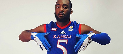 Incoming Kansas defensive end Willie McCaleb poses for photos during a recruiting visit to Lawrence.