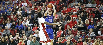 Kansas guard Sviatoslav Mykhailiuk (10) puts a three over UNLV guard Kris Clyburn (1) during the first half, Thursday, Dec. 22, 2016 at Thomas & Mack Center in Las Vegas.