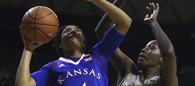 Kansas forward Jada Brown (4) shoots past Baylor forward/center Beatrice Mompremier (32) in the first half of an NCAA college basketball game, Sunday, Jan. 1, 2017, in Waco, Texas.