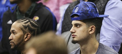 Arizona State transfer Sam Cunliffe, right, watches the action during the second half of Tuesday's game between the Jayhawks and Wildcats.