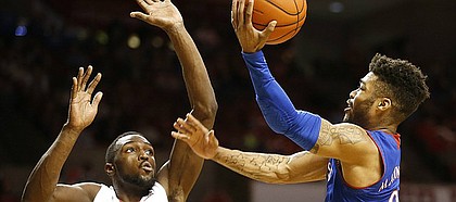 Kansas guard Frank Mason III (0) goes up to the bucket against Oklahoma forward Khadeem Lattin (12) during the second half, Tuesday, Jan. 10, 2017 at Lloyd Noble Center in Norman, Okla.