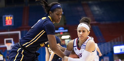 Kansas’ Jessica Washington (3) wrestles the ball from West Virginia’s Teana Muldrow (11) late in the third quarter of Wednesday night’s game. West Virginia won, 62-51.