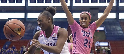Kansas guard Chayla Cheadle (22) drives between defenders in the Jayhawks’ game against TCU, Sunday in Allen Fieldhouse.