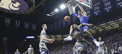 Kansas forward Landen Lucas (33) explodes for a dunk and a foul from Kansas State forward D.J. Johnson (4) during the second half, Monday, Feb. 6, 2017 at Bramlage Coliseum.