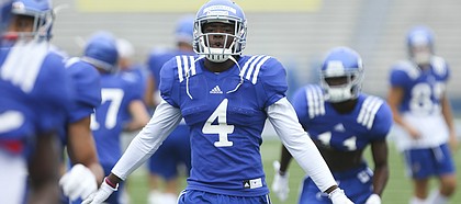 Kansas receiver Daylon Charlot soars back to get in line during team stretches at the beginning of practice on Monday, Aug. 15, 2016 at Memorial Stadium.