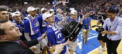Kansas guard Tyler Self is handed the Big 12 Conference trophy following the Jayhawks' 87-68 win over TCU, Wednesday, Feb. 22, 2017 at Allen Fieldhouse.