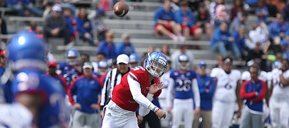 Kansas quarterback Carter Stanley (9) heaves a pass to a receiver during the Spring Game on Saturday, April 9, 2016 at Memorial Stadium.