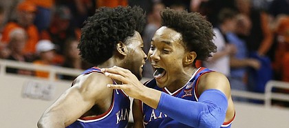 Kansas guard Devonte' Graham (4) and Kansas guard Josh Jackson (11) get airborne to celebrate the Jayhawks' 90-85 win, Saturday, March 4, 2017 at Gallagher-Iba Arena.