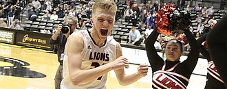 Lawrence High senior Jackson Mallory runs over to the Lions' student section to celebrate LHS' 41-36 win over Blue Valley North in the semifinals of the Class 6A state tournament on Friday at Wichita State's Charles Koch Arena. Mallory scored 12 points.