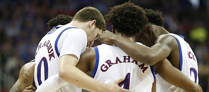 The Jayhawks come together during a timeout in the second half, Thursday, March 9, 2017 at Sprint Center.