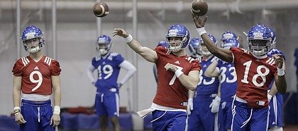 The Kansas football team practices inside Anschutz Pavilion, Monday, March 13, 2017. The practice was the first of the spring for the Jayhawks, including quarterbacks (from left) Carter Stanley, Peyton Bender and Tyriek Starks.