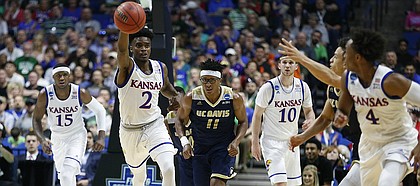 Kansas guard Lagerald Vick (2) pushes the ball up the court to Kansas guard Devonte' Graham (4) during the first half on Friday, March 17, 2017 at BOK Center in Tulsa, Oklahoma.